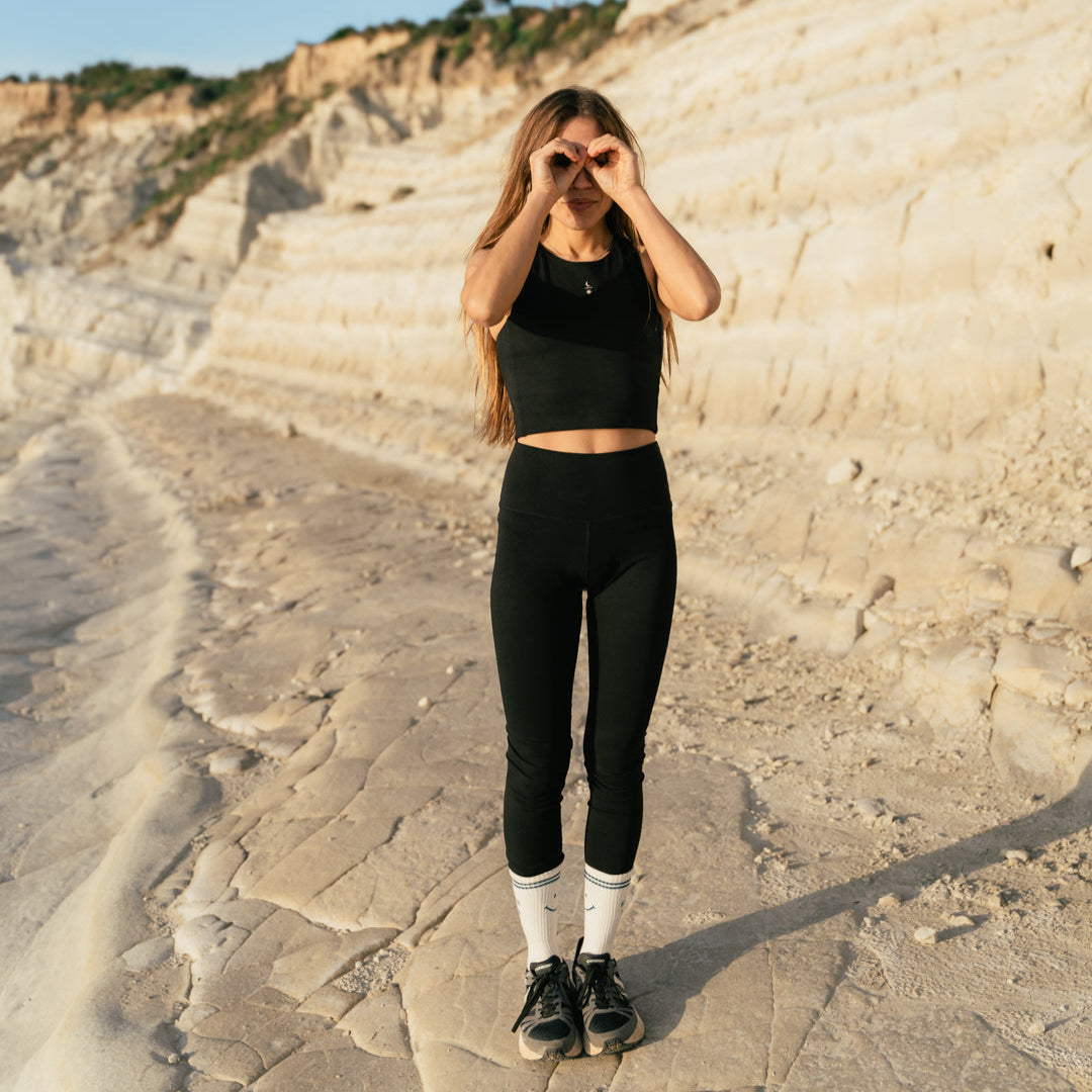 Front view of woman wearing the Ainé sustainable leggings and hybrid top made from PYRATEX MicroTencel. A complete natural activewear outfit.