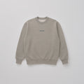 Flatlay image of Gray marle organic cotton sweatshirt in limited edition "Grey Matter" with a Studio Nidra logo embroidery on a light gray background